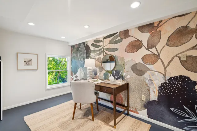 a living room with a bed and a window