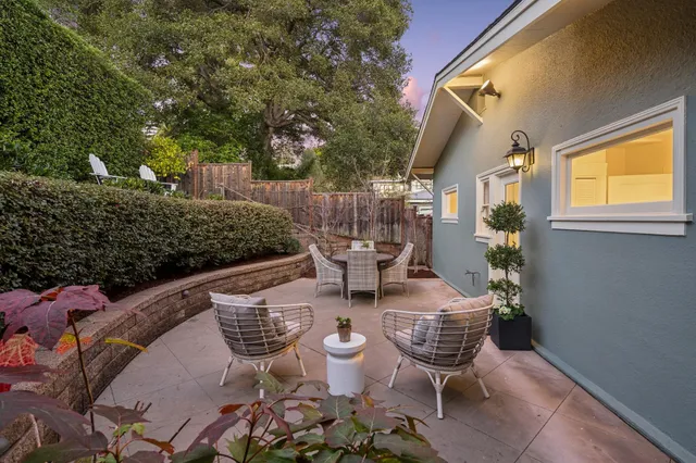 a view of a patio with table and chairs and potted plants