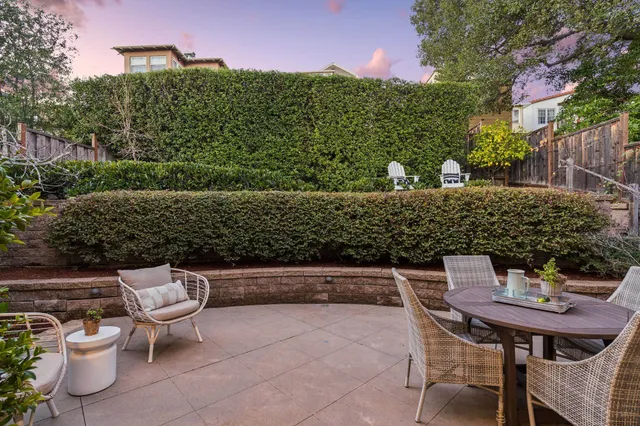 a view of a patio with a table and chairs
