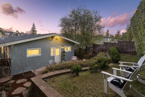 a view of a backyard with sitting area