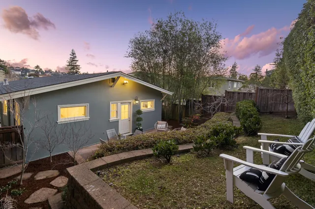 a view of a backyard with sitting area