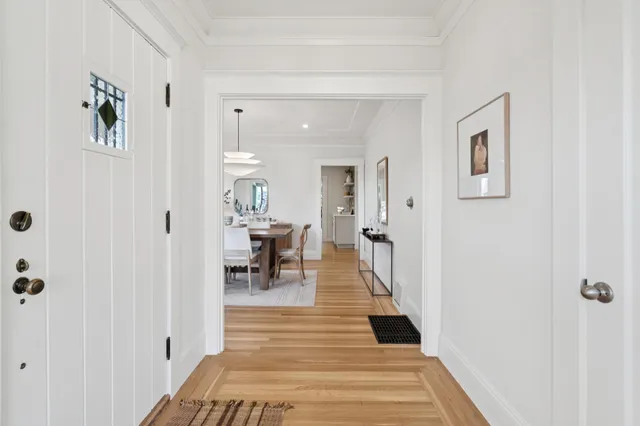 a hallway with wooden floor and furniture