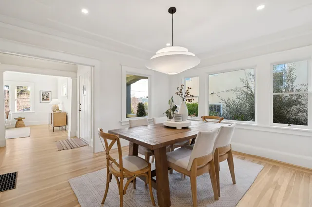 a view of a dining room with furniture window and wooden floor