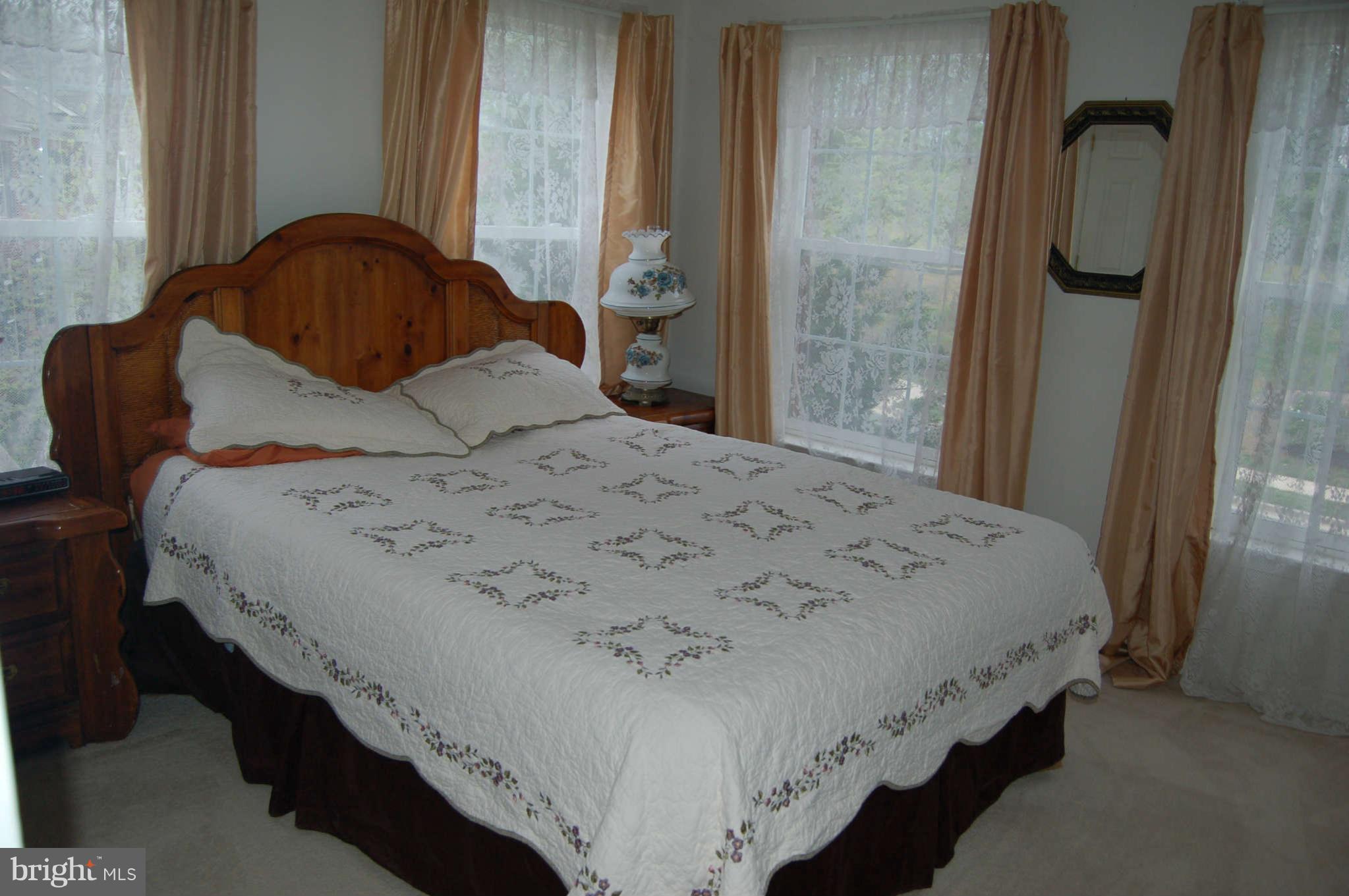 18812 Broken Oak Road Boyds, MD 20841 - Photo 18 of 30 a bedroom with a bed and a mirror