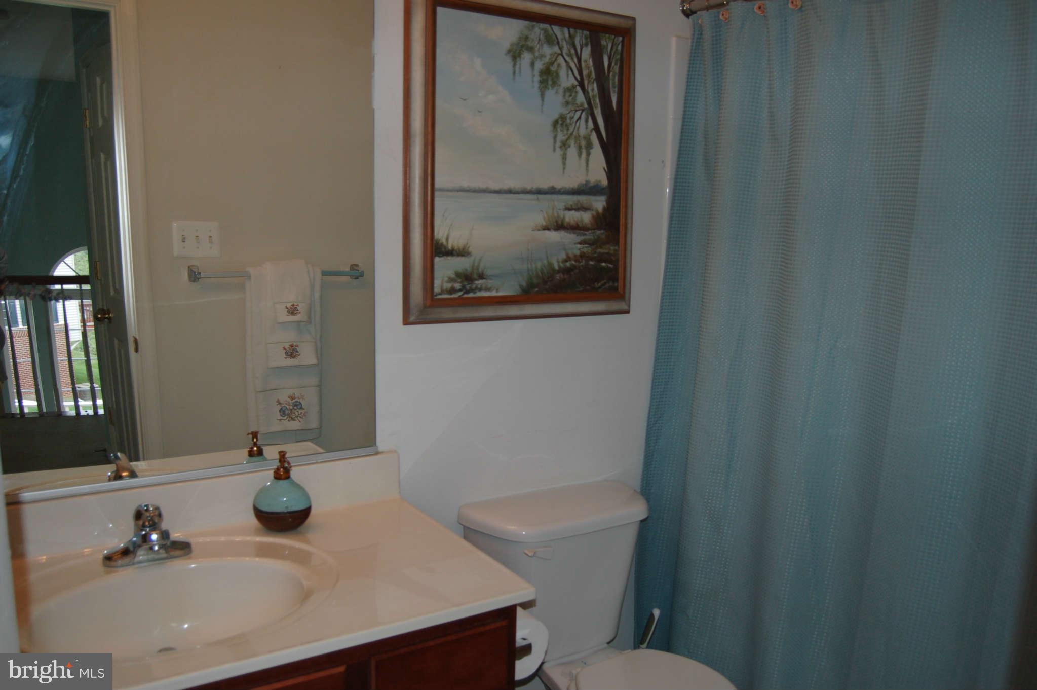 18812 Broken Oak Road Boyds, MD 20841 - Photo 19 of 30 a bathroom with a sink toilet and mirror
