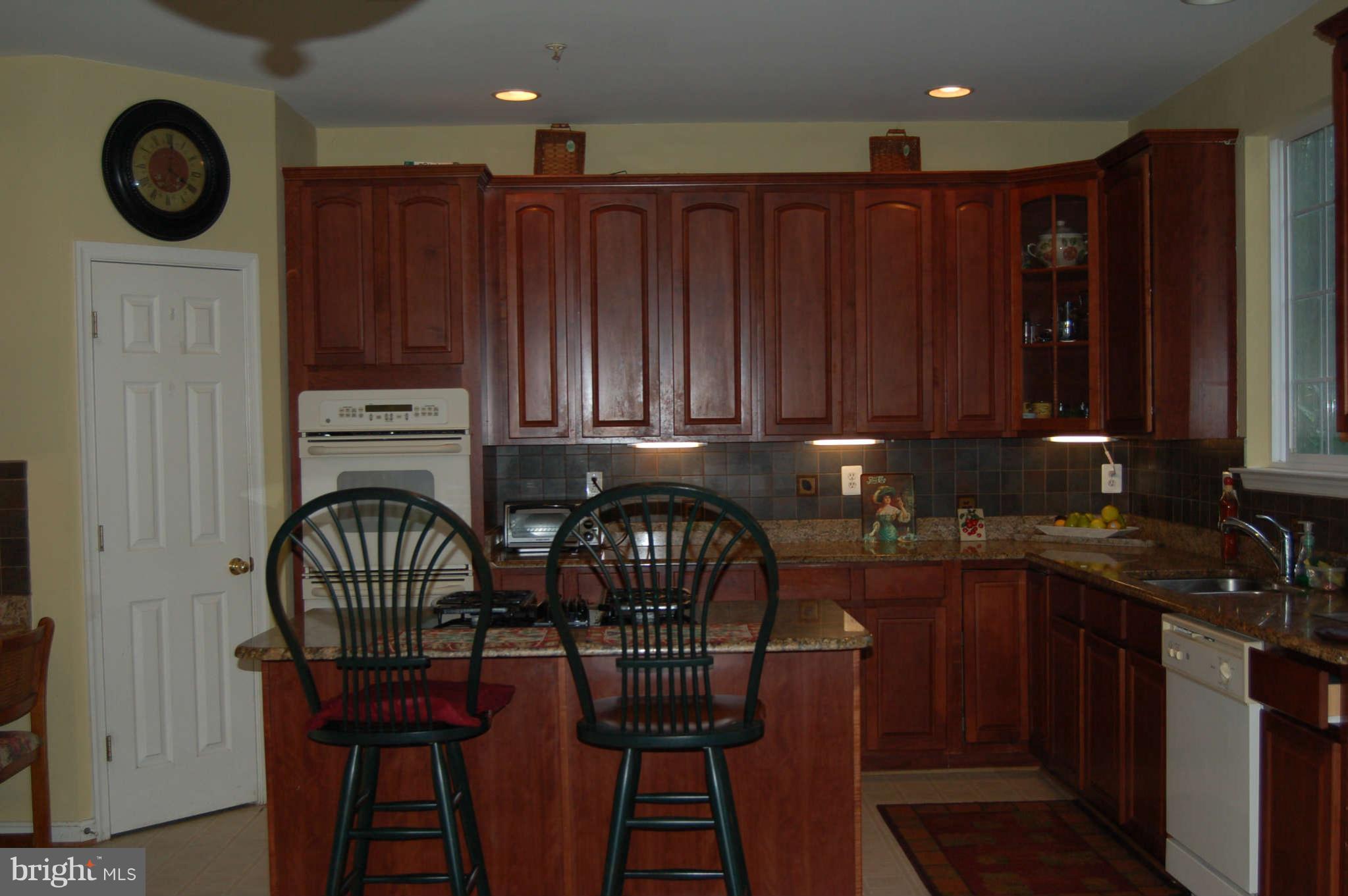 18812 Broken Oak Road Boyds, MD 20841 - Photo 5 of 30 a kitchen with granite countertop a stove a sink and a refrigerator