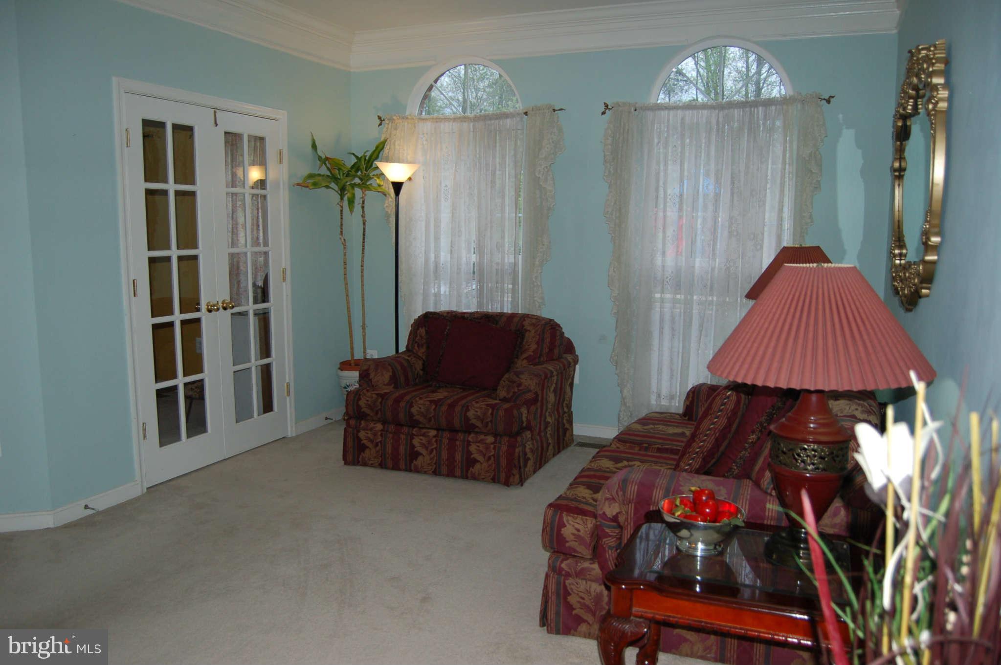 18812 Broken Oak Road Boyds, MD 20841 - Photo 8 of 30 a bedroom with furniture and a chandelier