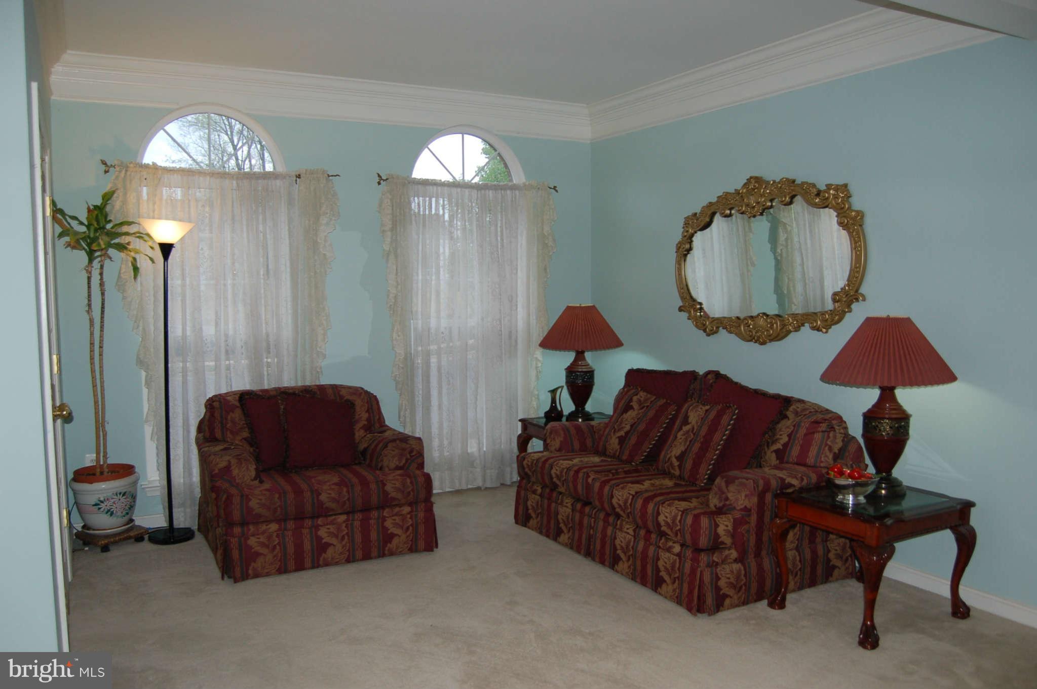 18812 Broken Oak Road Boyds, MD 20841 - Photo 9 of 30 a living room with furniture a lamp and a chandelier