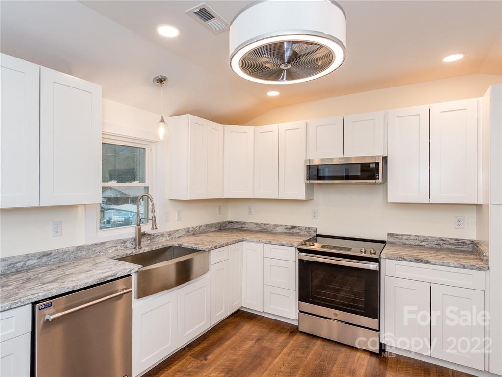 16 Jaffe Road Rosman, NC 28772 - Photo 7 of 20 a kitchen with stainless steel appliances granite countertop a stove a sink and a white cabinets