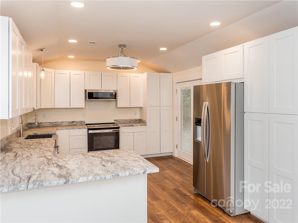 16 Jaffe Road Rosman, NC 28772 - Photo 8 of 20 a kitchen with stainless steel appliances granite countertop a refrigerator a stove and a sink
