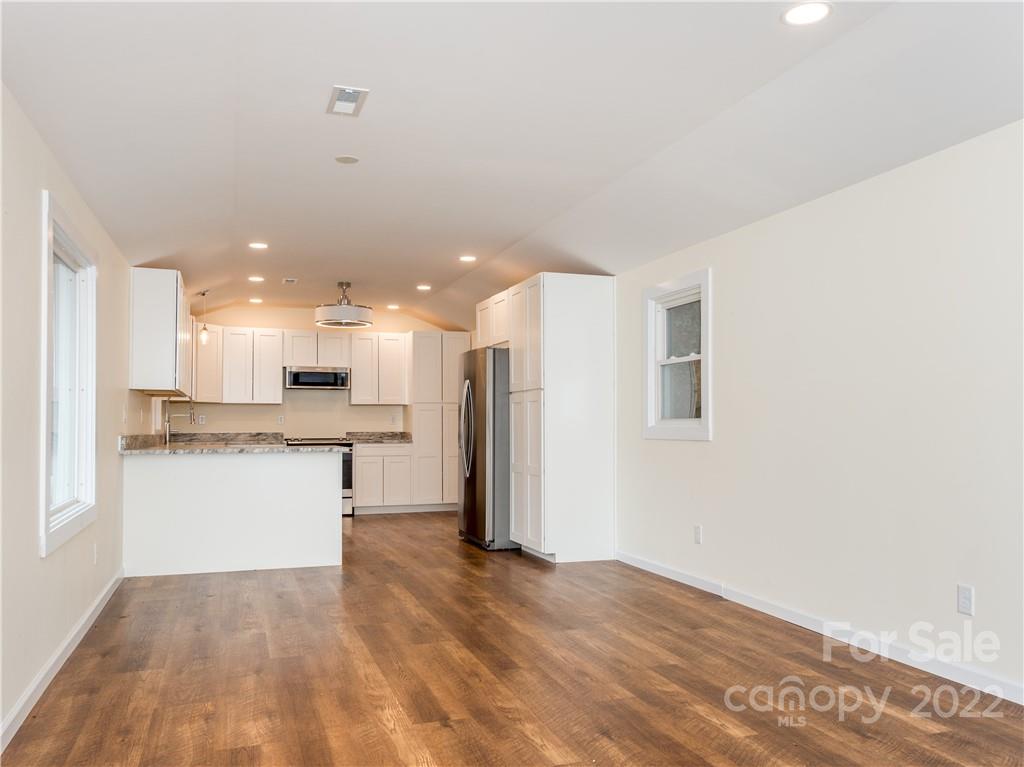 16 Jaffe Road Rosman, NC 28772 - Photo 9 of 20 a view of kitchen with kitchen island a sink wooden floor and a refrigerator