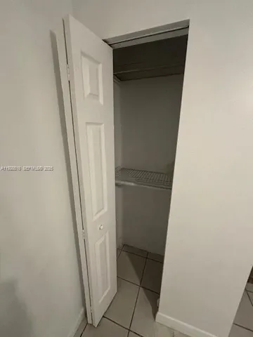 a white refrigerator freezer and a stove sitting inside of a kitchen
