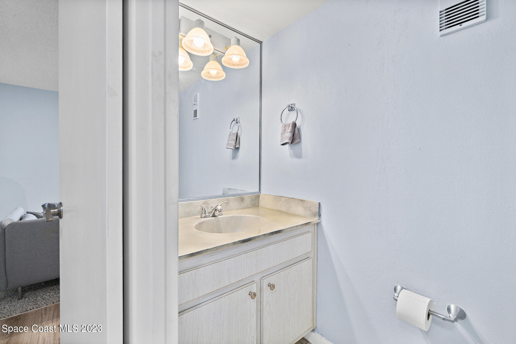 500 Catalina Road, Unit 103 Cocoa Beach, FL 32931 - Photo 20 of 28 a bathroom with a sink and a mirror