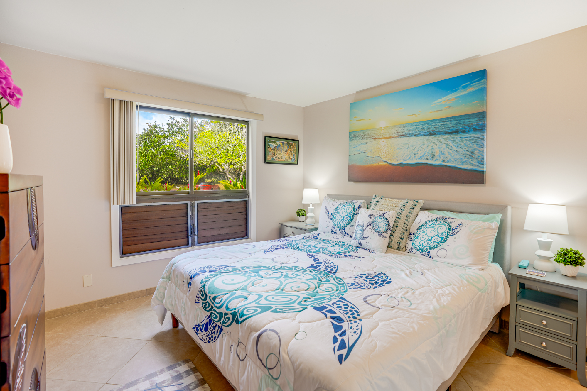 4330 Kauai Beach Drive, Unit E13 Lihue, HI 96766 - Photo 11 of 30 a bedroom with a bed and wooden floor