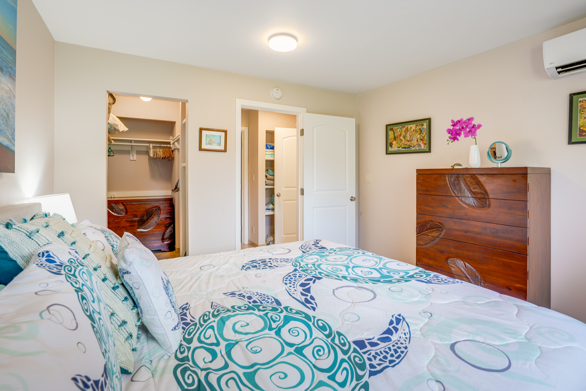 4330 Kauai Beach Drive, Unit E13 Lihue, HI 96766 - Photo 17 of 30 a bedroom with a bed and wooden floor