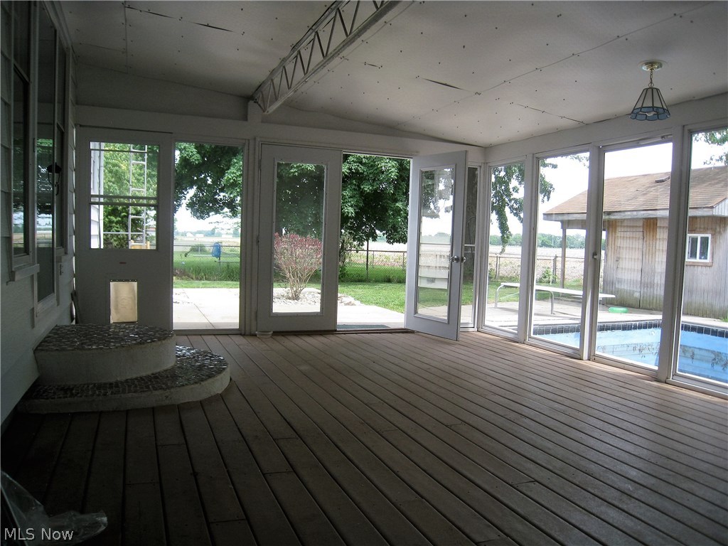 646 Rice Street Elmore, OH 43416 - Photo 12 of 20 Large enclosed sunporch with new roof, composite deck flooring, and wall of windows, or screens for the warmer weather, makes a great place to entertain or enjoy your private views! Pool is being professionally cleaned, painted and prepped to enjoy the summer season!