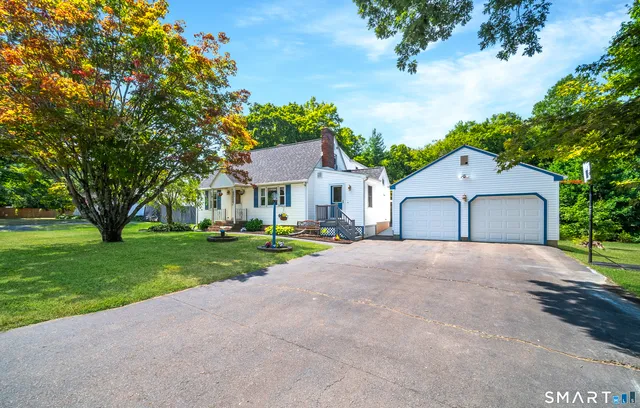 a front view of house with yard and green space