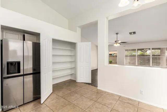 a view of walk in closet with empty racks