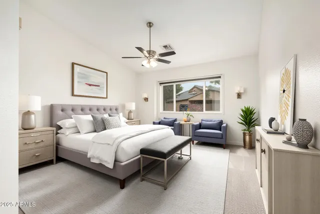 a bedroom with a bed couch and window