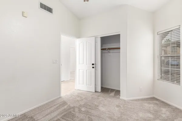 a view of an empty room with windows