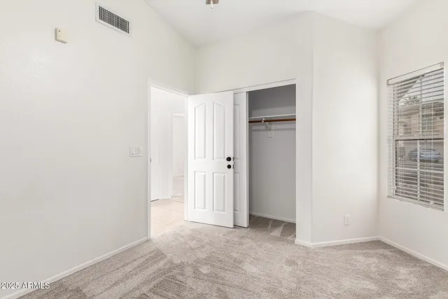 a view of an empty room with windows