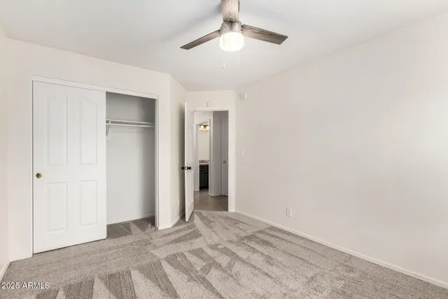 a view of empty room with ceiling fan
