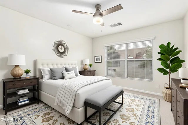 a bedroom with a large bed and a chandelier