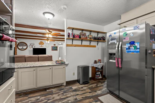 a kitchen with stainless steel appliances granite countertop a refrigerator and a sink