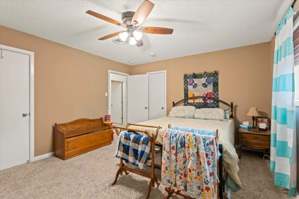 a bedroom with a bed and a chandelier