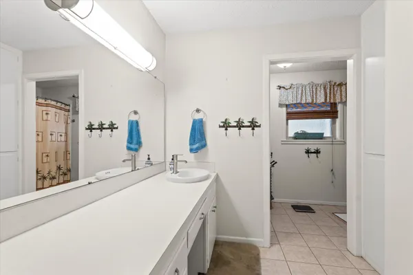 a bathroom with a double vanity sink and mirror