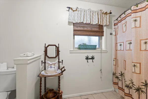 a view of a room with table and chairs