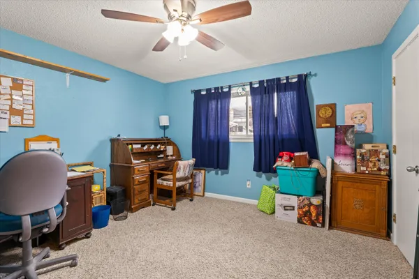 a bedroom with a workspace