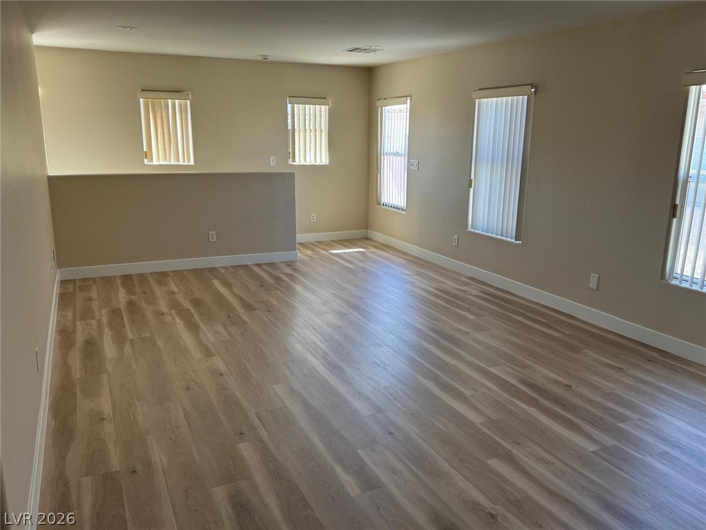 3962 Coyote Ridge Court Las Vegas, NV 89129 - Photo 28 of 35 Natural light illuminates the extensive plank flooring throughout this open concept living space.