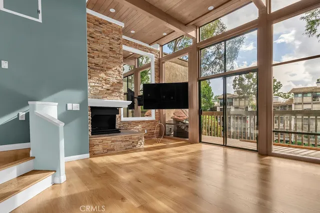 a view of a livingroom with fireplace and window