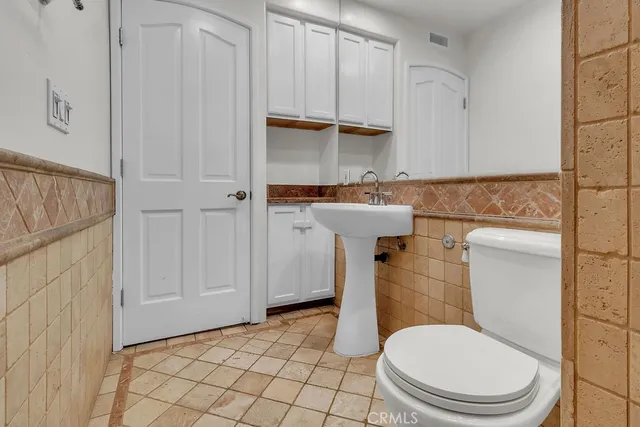 a bathroom with a sink a toilet and a shower