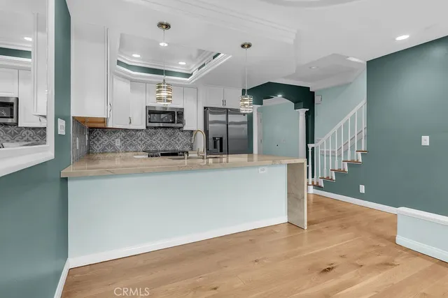 a view of a kitchen with a sink and cabinets