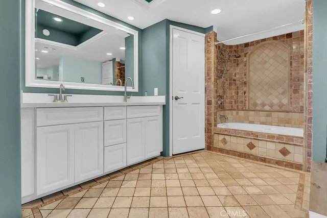 a bathroom with a shower a sink and a mirror