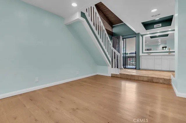 a view of entryway and hall with wooden floor