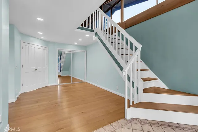 a view of entryway and hall with wooden floor