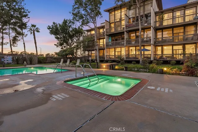 a view of a swimming pool with a patio and a yard