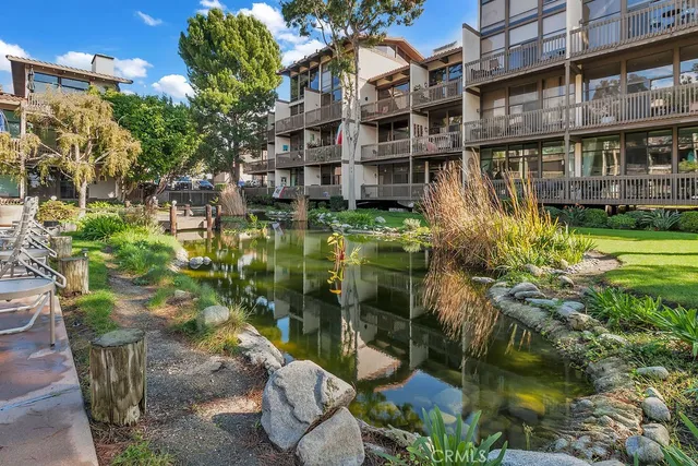 a backyard of a house with a yard and outdoor seating