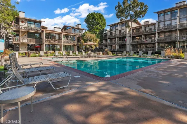 a swimming pool view with a outdoor seating
