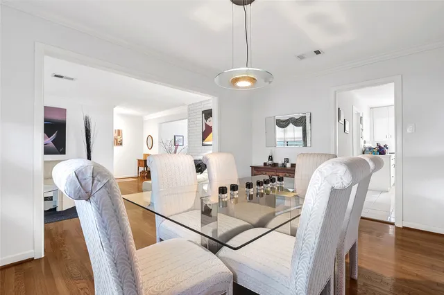 a view of a dining room with furniture wooden floor and chandelier