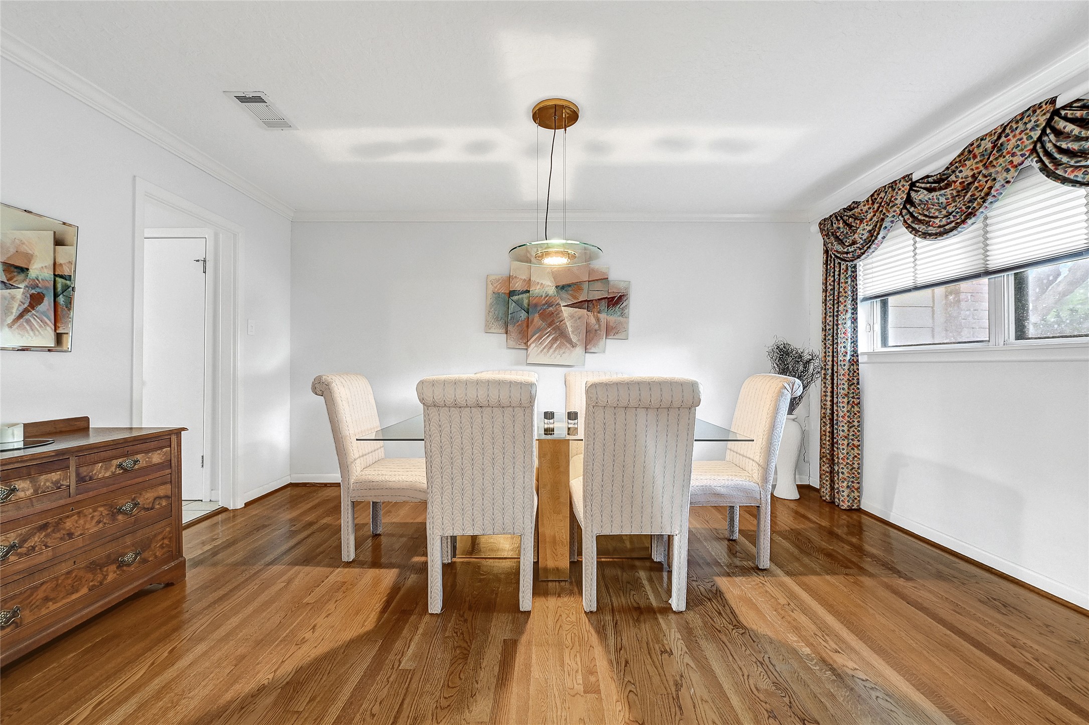 4831 Knickerbocker Street Houston, TX 77035 - Photo 2 of 50 a dining room with furniture a chandelier and wooden floor