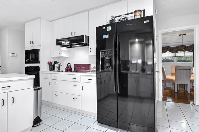 a kitchen with a refrigerator and cabinets