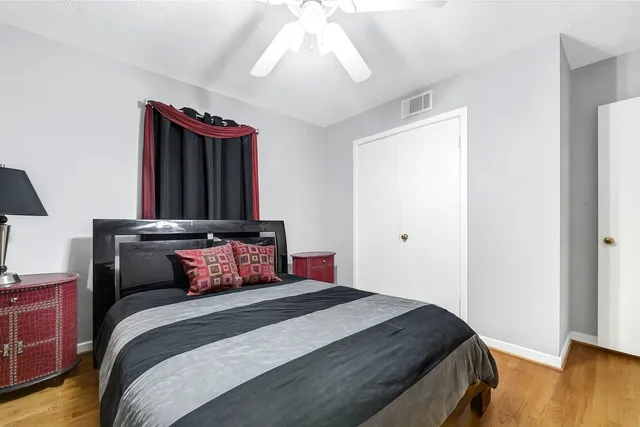 a bedroom with bed and wooden floor