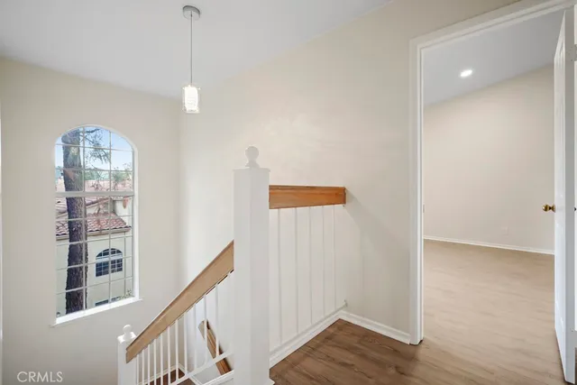 a view of hallway with wooden floor and stairs