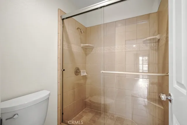 a bathroom with a shower and toilet