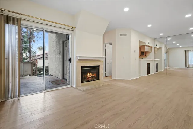a view of a livingroom with a fireplace and window