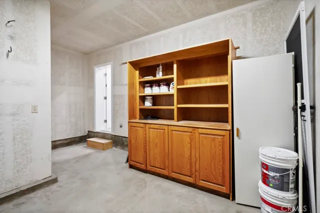 a view of an empty room with furniture and staircase